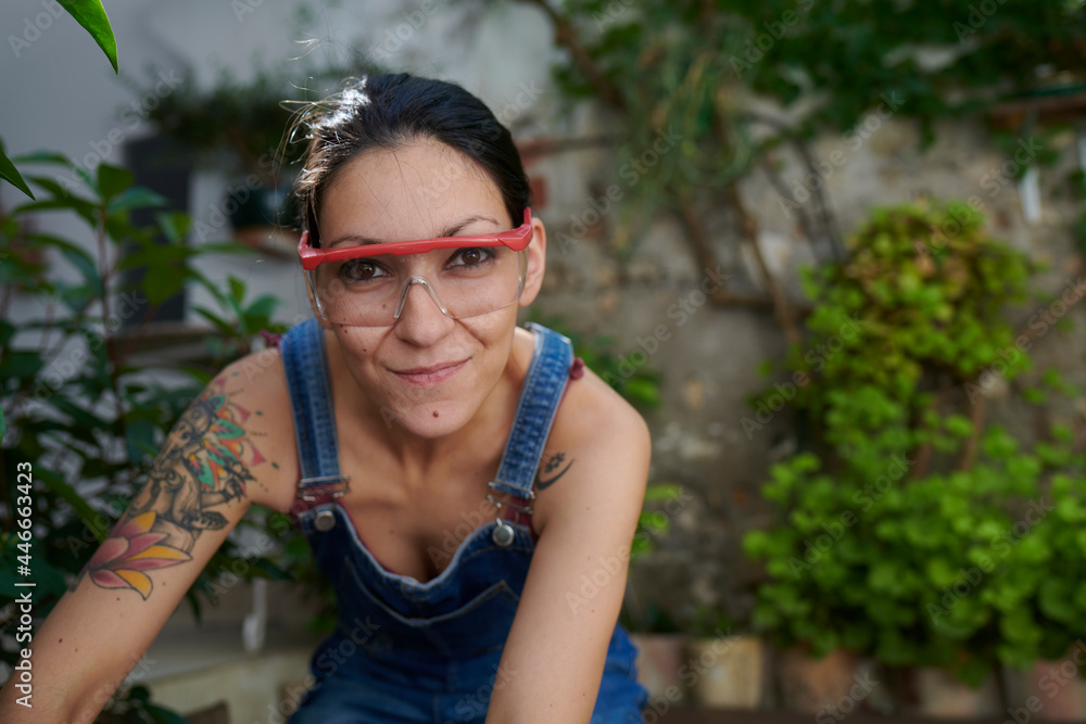 A smiling young woman with safety goggles looking at the camera. A smiling young woman with safety goggles looking at the camera.