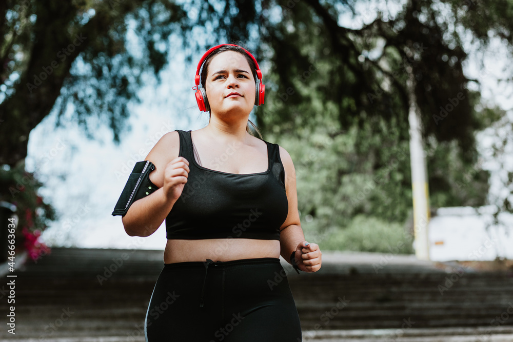 © Cavan Images - plus size young latin woman running in park in Mexico © Cavan Images - plus size young latin woman running in park in Mexico