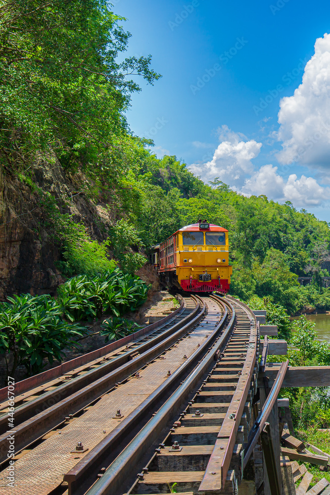 Fototapeta premium Kanchanaburi Province, Locomotive, Steam Train, Thailand, Train,World war II historic railway, known as the Death Railway with a lot of tourists on the train taking photos of beautiful views over Kwai