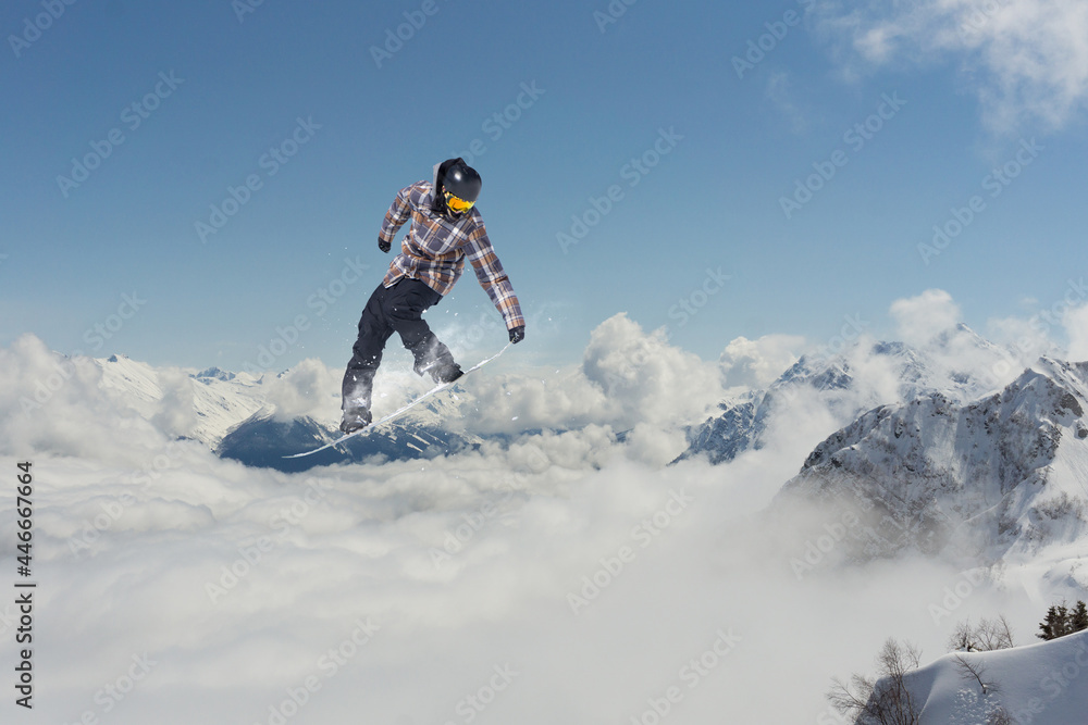 Flying snowboarder on mountains. Extreme sport.