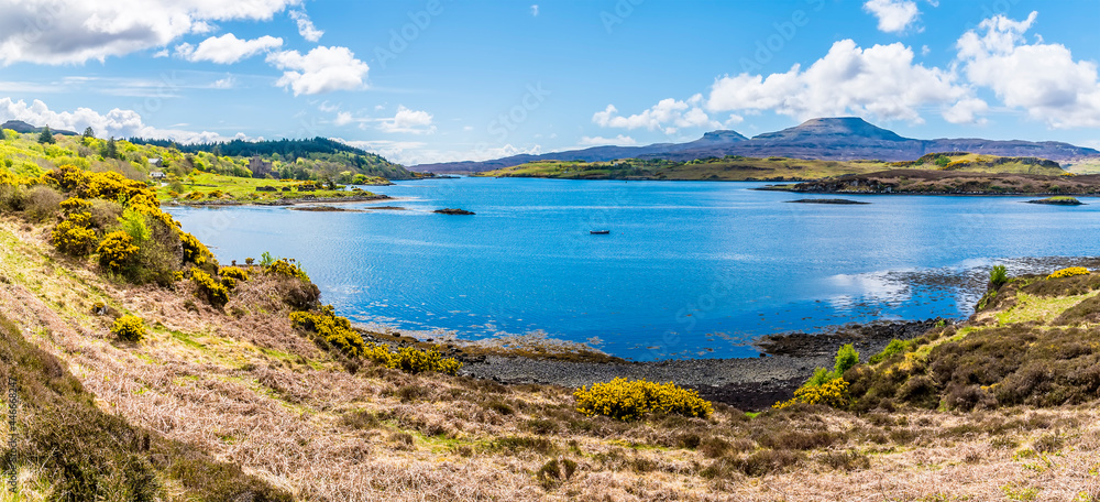 A panorama view across Loch Dunvegan on the island of Skye towards MacCleods Tables, Scotland on a summers day