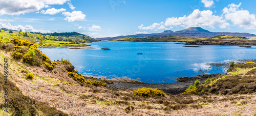 A panorama view across Loch Dunvegan on the island of Skye towards MacCleods Tables, Scotland on a summers day