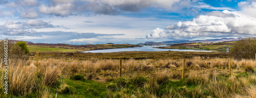 A panorama view across the heathland towards Loch Snizort Beag on the island of Skye, Scotland on a summers day