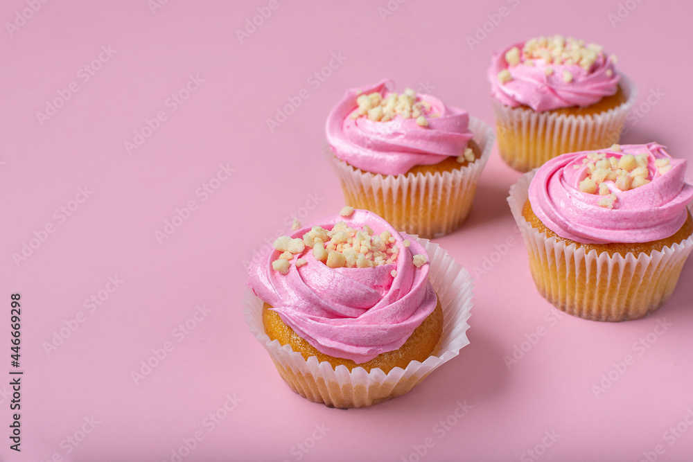 Cupcakes on a pink background. Cupcakes with yogurt and strawberry cream. Strawberry cupcakes.