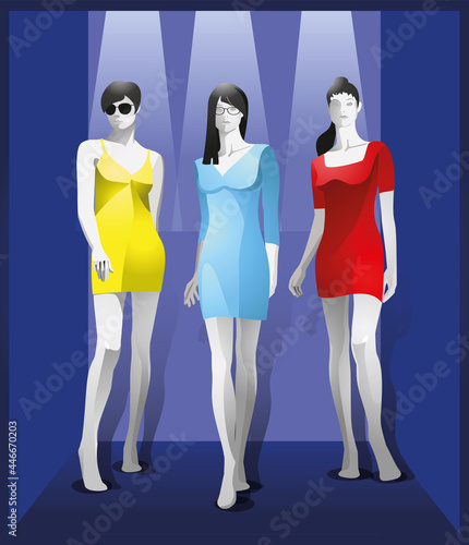 Female mannequins in bright summer dresses.