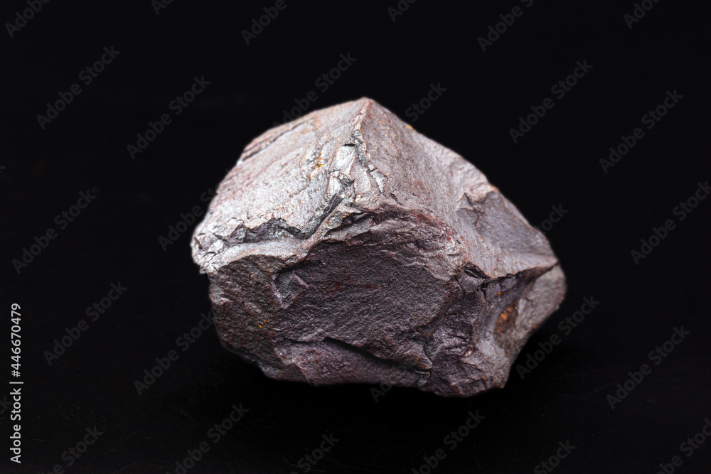 Iron ore on isolated black background, metal used in metallurgical industry.