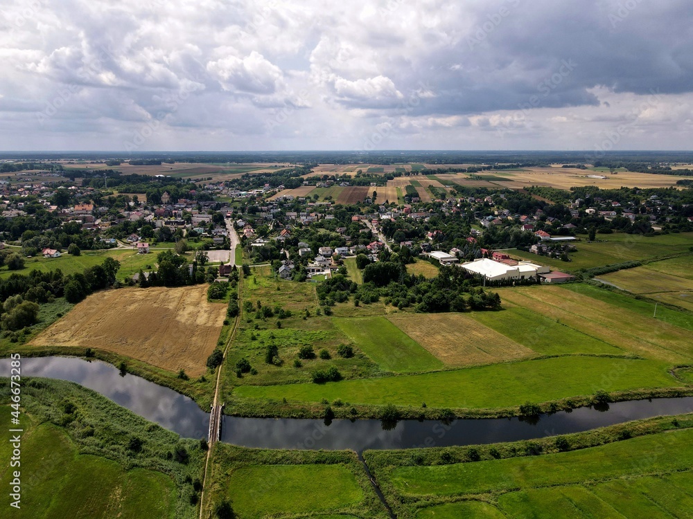 Fields, meadows in rural green areas by the river - top view - drone photo