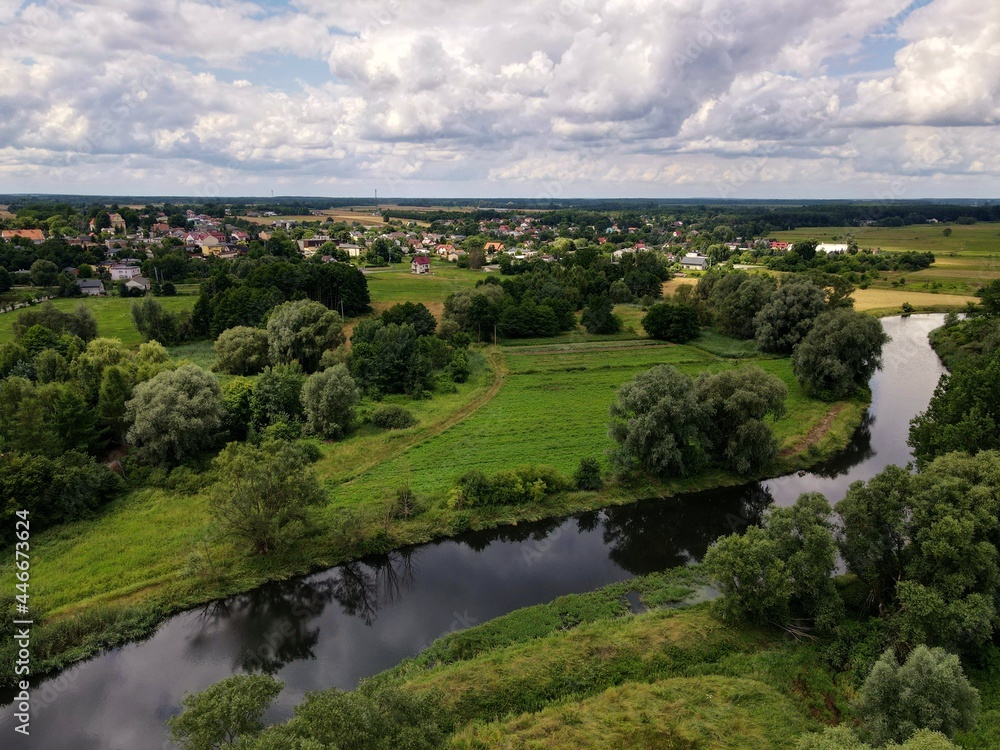 Fields, meadows in rural green areas by the river - top view - drone photo