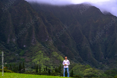 Man standing in front of mountains in Hawaii 