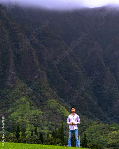 Man standing in front of mountains in Hawaii
