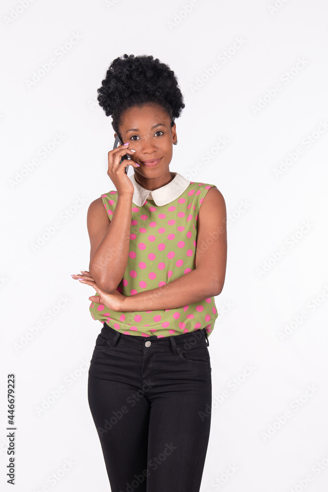 Latina woman patiently talking on her phone looking at the camera: Expressions concept. Latina woman patiently talking on her phone looking at the camera: Expressions concept.