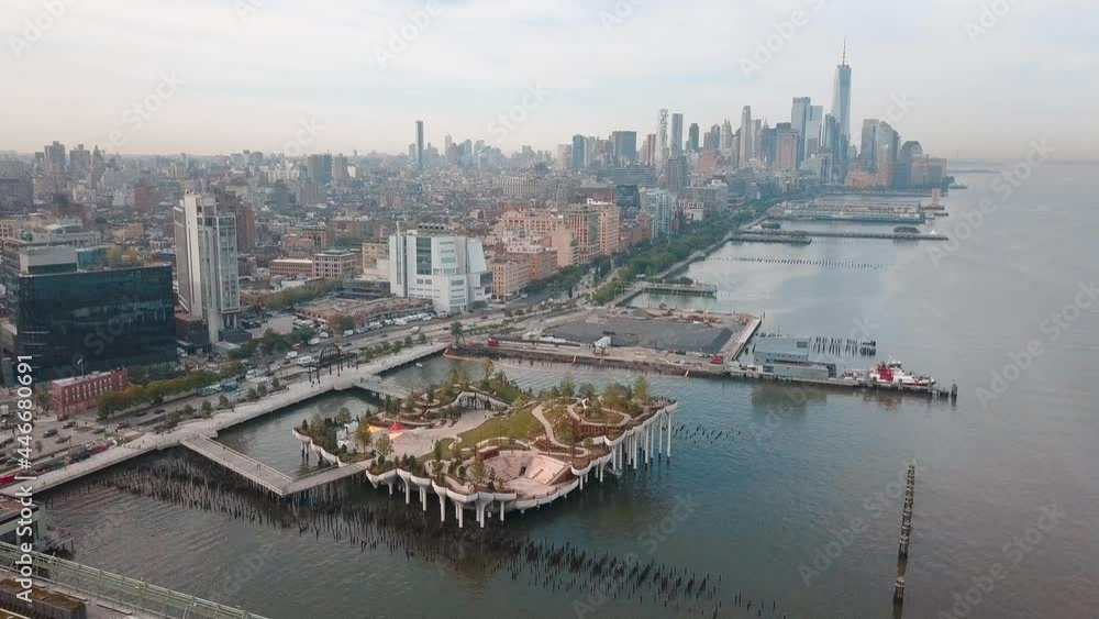 Little Island park at Pier 55 in New York new landmark of the city with Manhattan skyscrapers rising above Little Island park at Pier 55 in New York new landmark of the city with Manhattan skyscrapers rising above