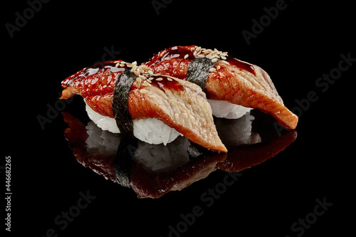Two nigiri sushi with eel, unagi sauce and sesame photo