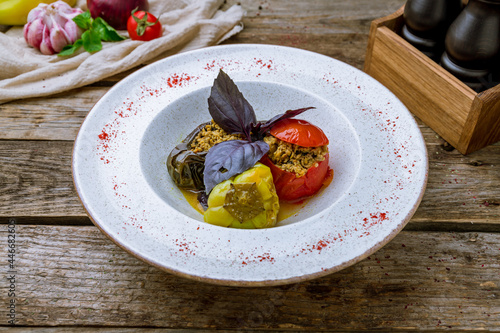 dolma in azerbaijani on plate on old wooden table photo