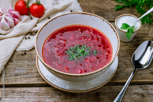 Borscht with sour cream on old wooden talbe photo