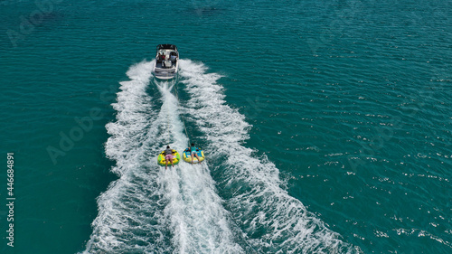 Aerial photo of extreme power boat donut water-sports cruising in high speed in tropical emerald bay © aerial-drone