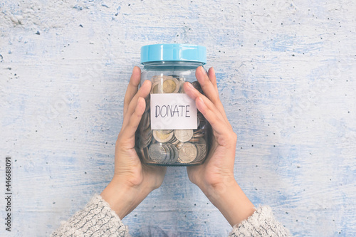 Woman holding a money jar, donation, saving, charity, family finance plan concept, superannuation concept. photo