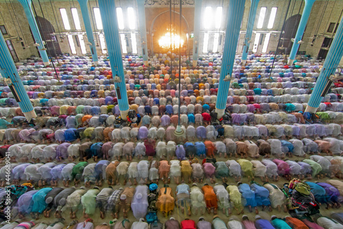 View of several people praying and worshipping in one of the biggest islamic mosque in the world, Dhaka, Bangladesh. photo