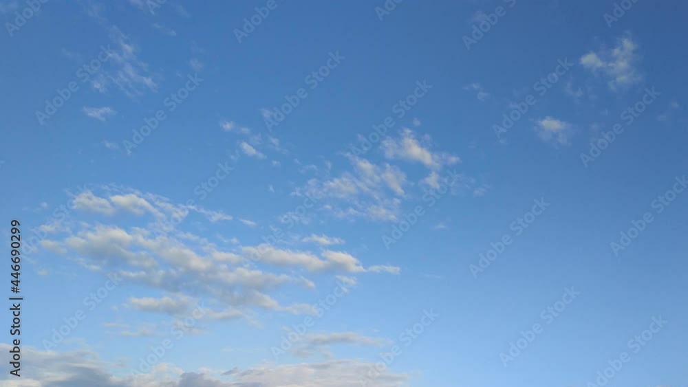 rare clouds that appear and disappear in the blue sky, highlighted by the low sunset sun from below in pink and yellow tones - time-lapse rare clouds that appear and disappear in the blue sky, highlighted by the low sunset sun from below in pink and yellow tones - time-lapse