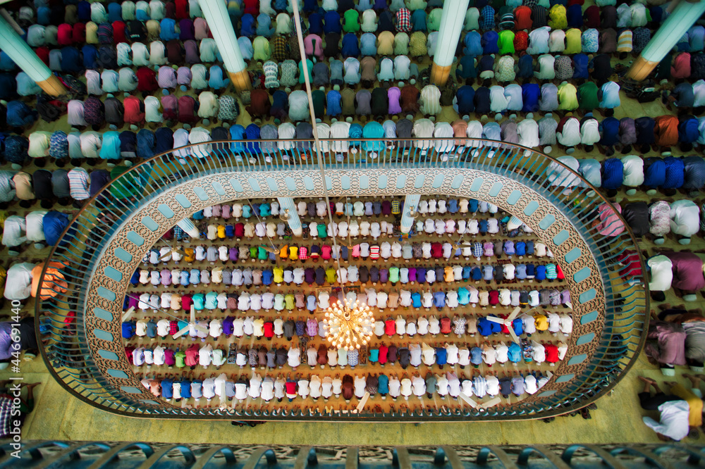View of many people praying in a big islamic mosque in Dhaka, Bangladesh. View of many people praying in a big islamic mosque in Dhaka, Bangladesh.