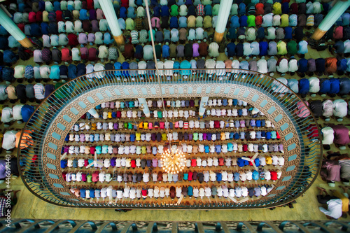 View of many people praying in a big islamic mosque in Dhaka, Bangladesh. photo