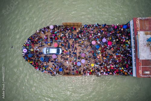 Aerial view of people crossing the river on the ferry at Mawa Ferry during Covid Pandemic restrictions, Munshiganj, Bangladesh. photo