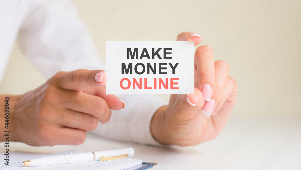 'make money online' card in the woman's hands. Business, Ethics, Advertising, Marketing. 'make money online' card in the woman's hands. Business, Ethics, Advertising, Marketing.