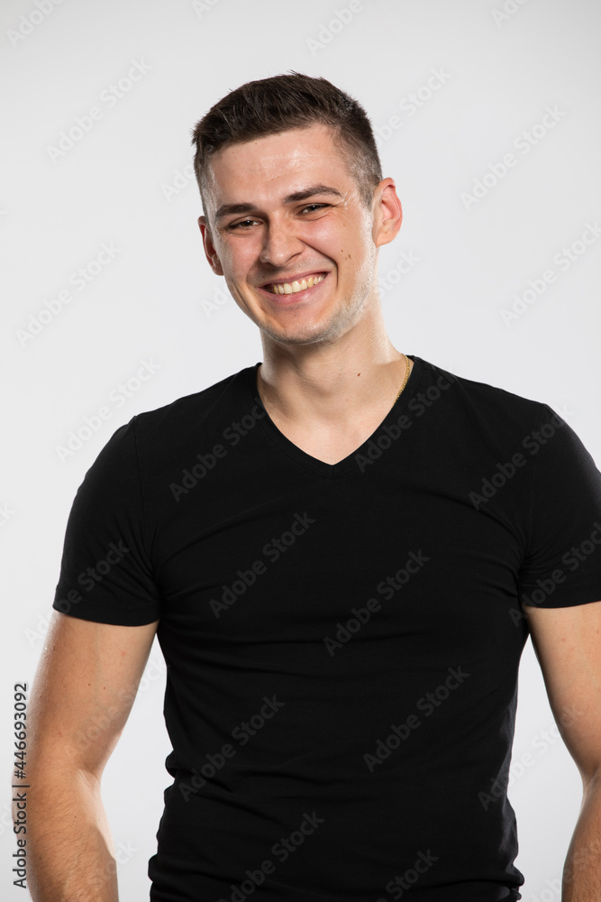 Portrait of a young handsome and smiling man. A boy wearing a black t-shirt. Portrait of a young handsome and smiling man. A boy wearing a black t-shirt.