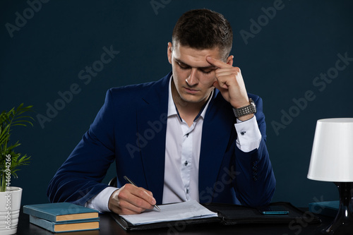 A young businessman analyzes the provisions of a contract he is about to sign with a large company.