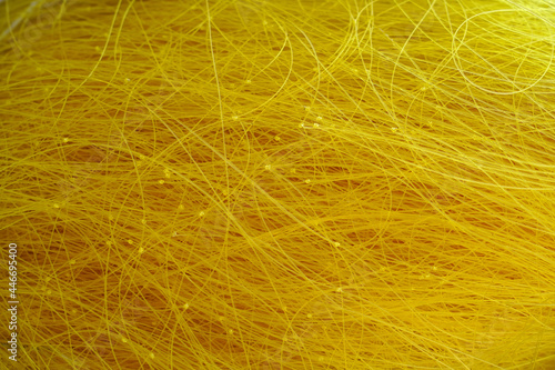 Yellow fishing line carelessly collected in a pile, texture background