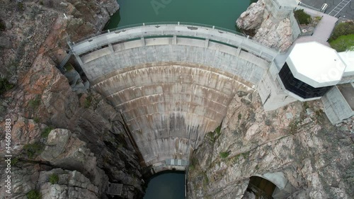 Aerial 4K view of large concrete arch-gravity dam. Drone footage from above Buffalo Bill Dam in Cody, Wyoming. photo