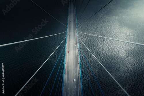 Aerial view of vehicle driving on Russkiy Bridge crossing the bay in Vladivostok, Russia. photo