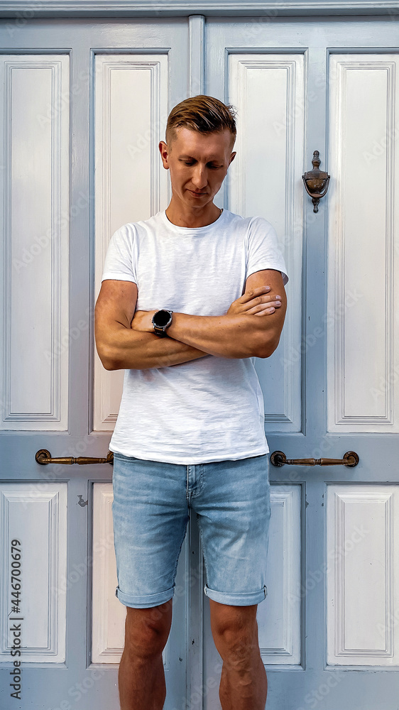 A man standing in front of a mirror posing for the camera A man standing in front of a mirror posing for the camera