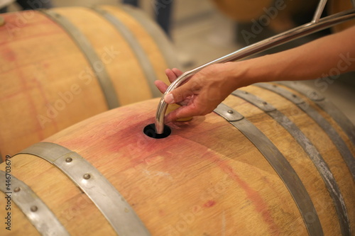 Nagano,Japan-July 22, 2021: Ouillage or Ullage to wine barrel using watering can
 photo