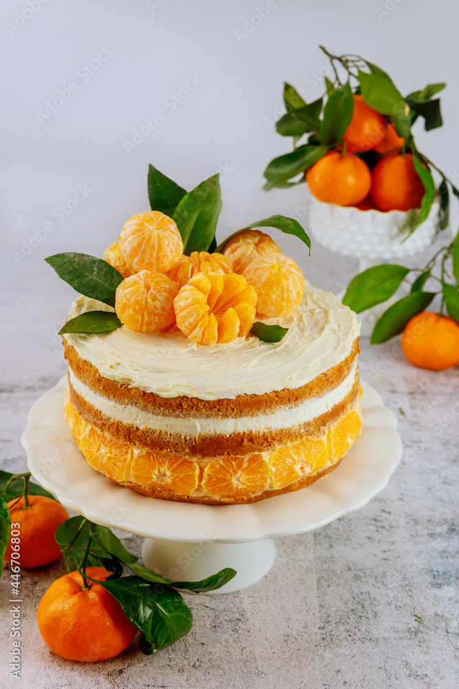 Citrus cake decorated with fresh tangerine and leaves. Citrus cake decorated with fresh tangerine and leaves.