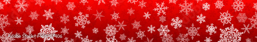Banner of complex Christmas snowflakes with seamless horizontal repetition  in red colors. Winter background with falling snow