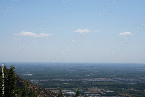 The top of the mountain overlooks the suburbs of Beijing in the distance