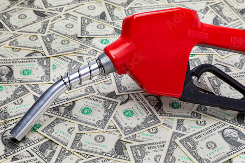 Fotografie Gasoline fuel nozzle and cash money