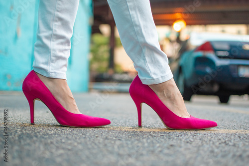 Bright Hot Pink High Heel Shoes with White Jeans Walking in the City Downtown