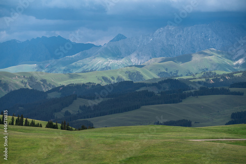 Grassland and mountains in a cloudy day. Photo in Kalajun grassland in Xinjiang, China.