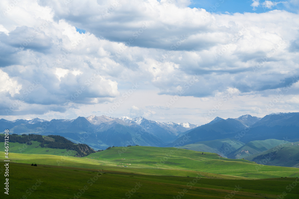 Grassland and mountains in a cloudy day. Photo in Kalajun grassland in Xinjiang, China. Grassland and mountains in a cloudy day. Photo in Kalajun grassland in Xinjiang, China.