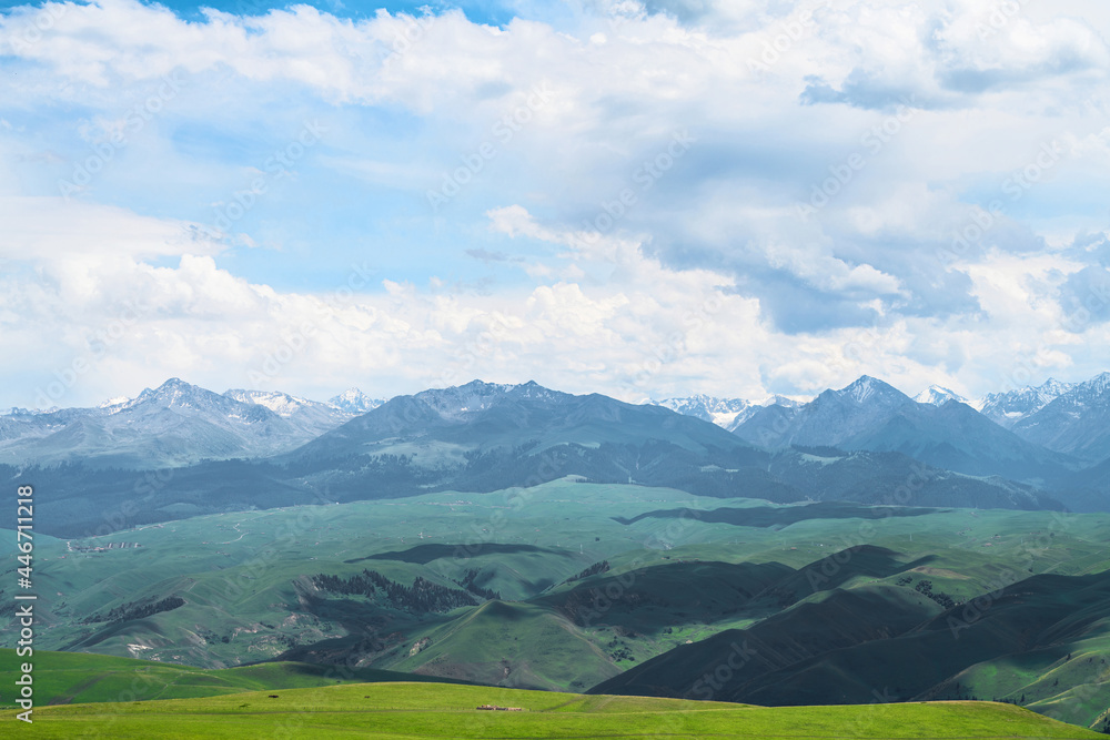 Grassland and mountains in a cloudy day. Photo in Kalajun grassland in Xinjiang, China. Grassland and mountains in a cloudy day. Photo in Kalajun grassland in Xinjiang, China.
