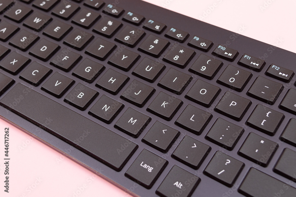 Black Bluetooth Keyboard for Tablet or PC on Pink Background Black Bluetooth Keyboard for Tablet or PC on Pink Background