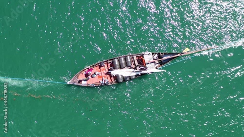 Aerial top down showing rabelo Boat transporting wine barrel on ship during cruise on Douro River in Portugal. photo