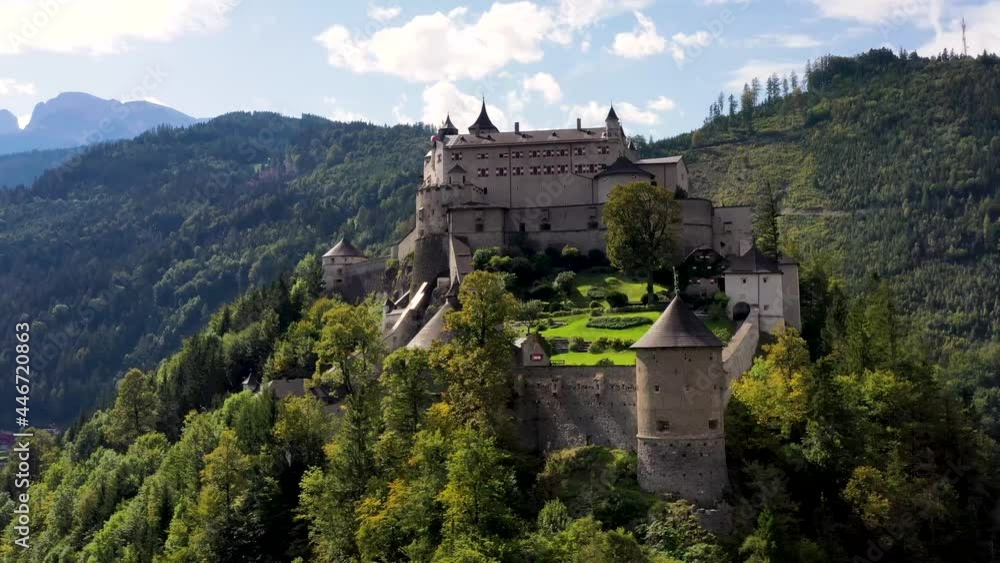 Aerial view of alpine castle Werfen (Hohenwerfen) near Salzburg, Austrian Alps, Austria, Europe. Medieval rock fortress with spruces. Overlooking the Werfen town in Salzach valley. Summer Aerial view of alpine castle Werfen (Hohenwerfen) near Salzburg, Austrian Alps, Austria, Europe. Medieval rock fortress with spruces. Overlooking the Werfen town in Salzach valley. Summer