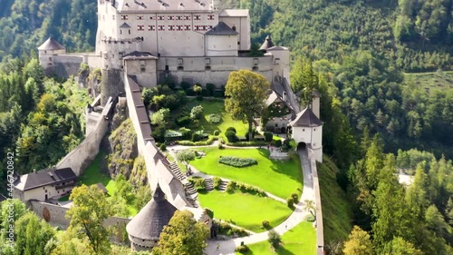 Spectacular aerial view of alpine castle Werfen (Hohenwerfen) near Salzburg, Austrian Alps, Austria, Europe. Medieval rock fortress with spruces. Overlooking the Werfen town in Salzach valley. Summer photo
