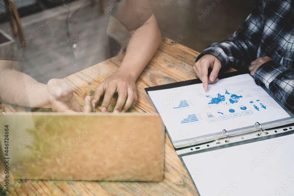 Two business people discussing business document together in modern office. Two business people discussing business document together in modern office.