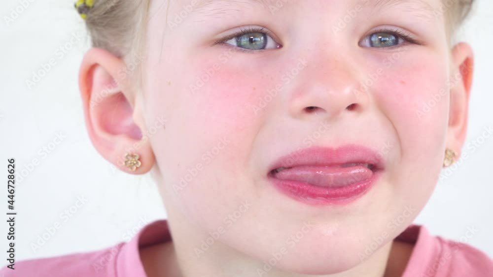 Close up saliva. drool on tongue little girl. The child shows the