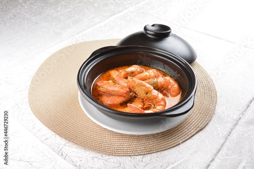 braised cook big fresh tiger prawn with red spicy curry soup in hot clay pot asian halal seafood menu