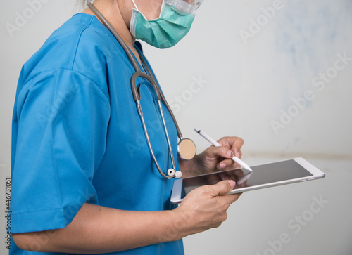 Medicine doctor/Nures working with her digital tablet in the hospital. medical staff in uniform photo